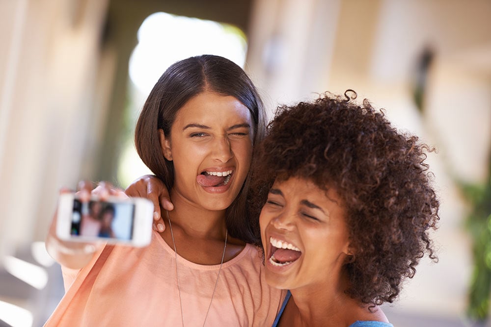 Two women college students taking a selfie.